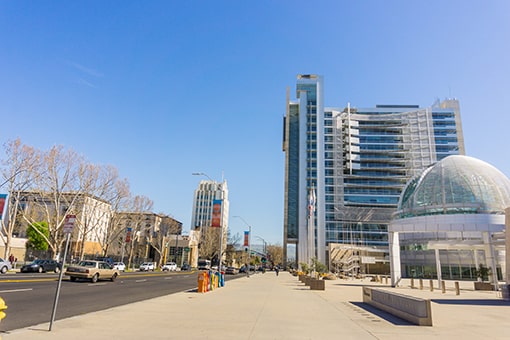 Image of tall buildings taken from footpath